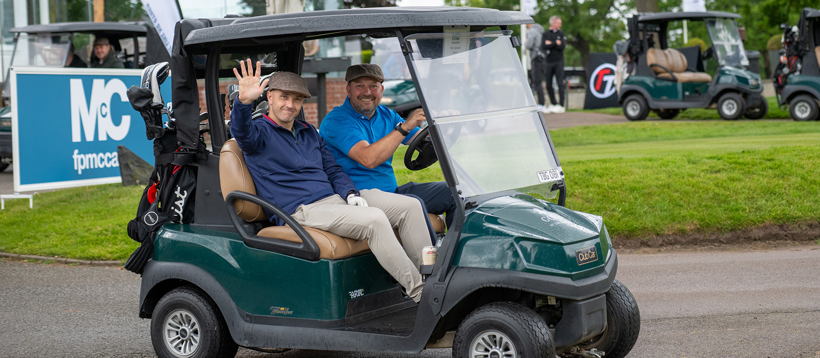 Golfers driving a buggy on the golf course
