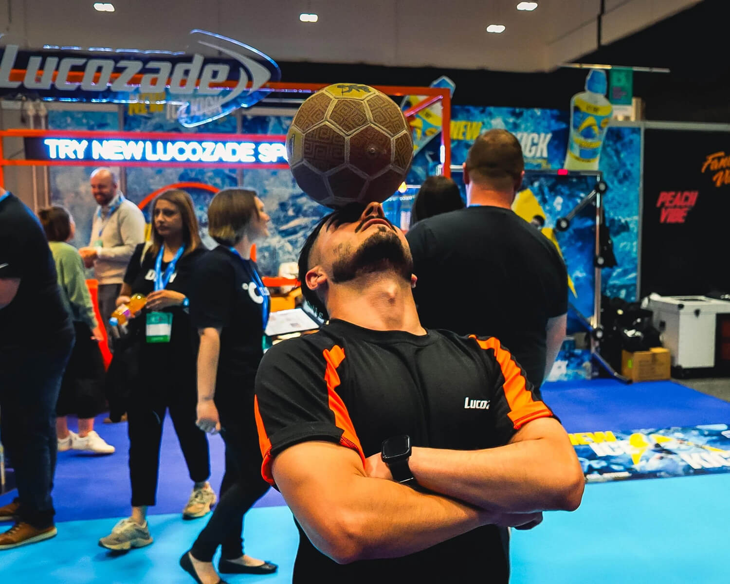 Exhibitor balancing a football on his forehead