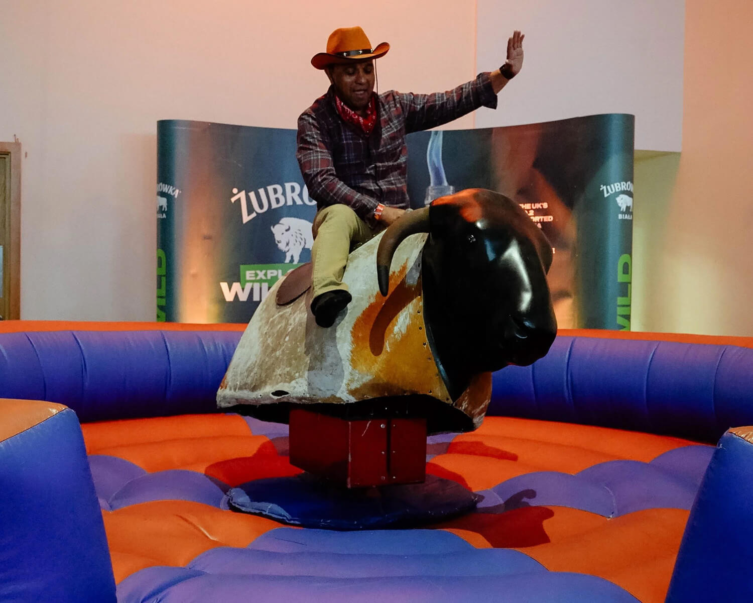 Event attendee using the bull riding machine at the Bestway Retail Showcase