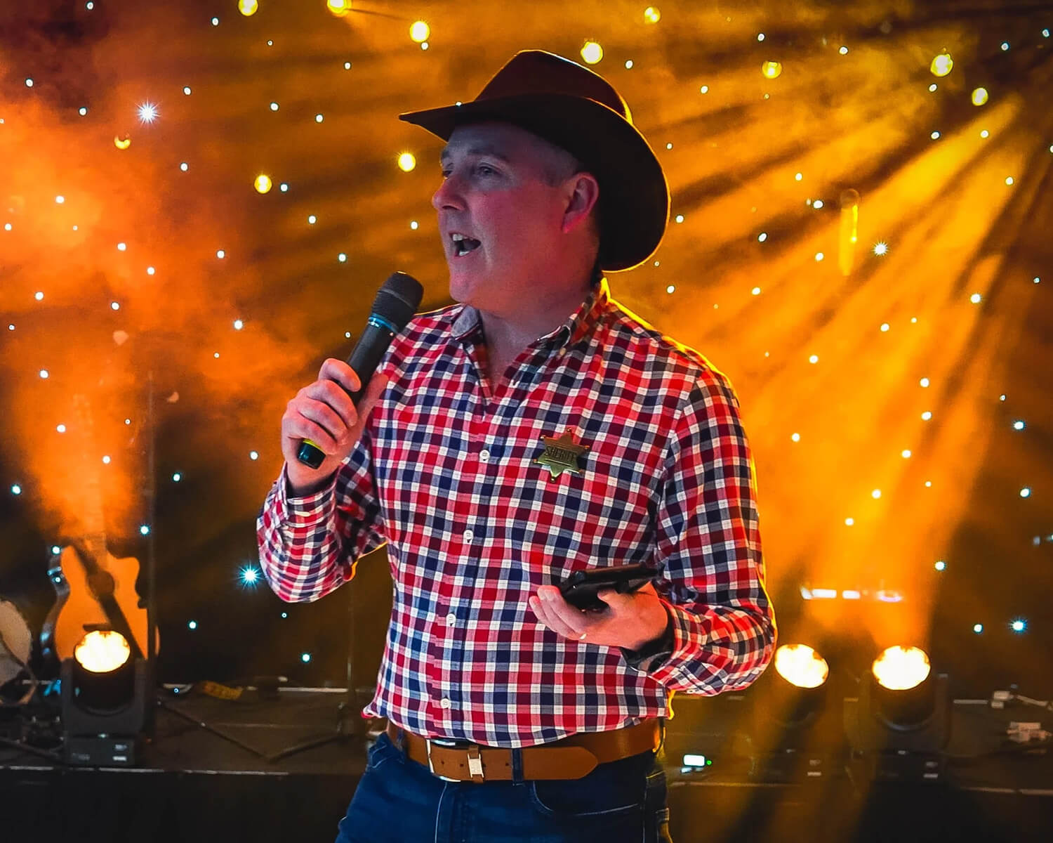 Evening performer on stage in a cowboy hat