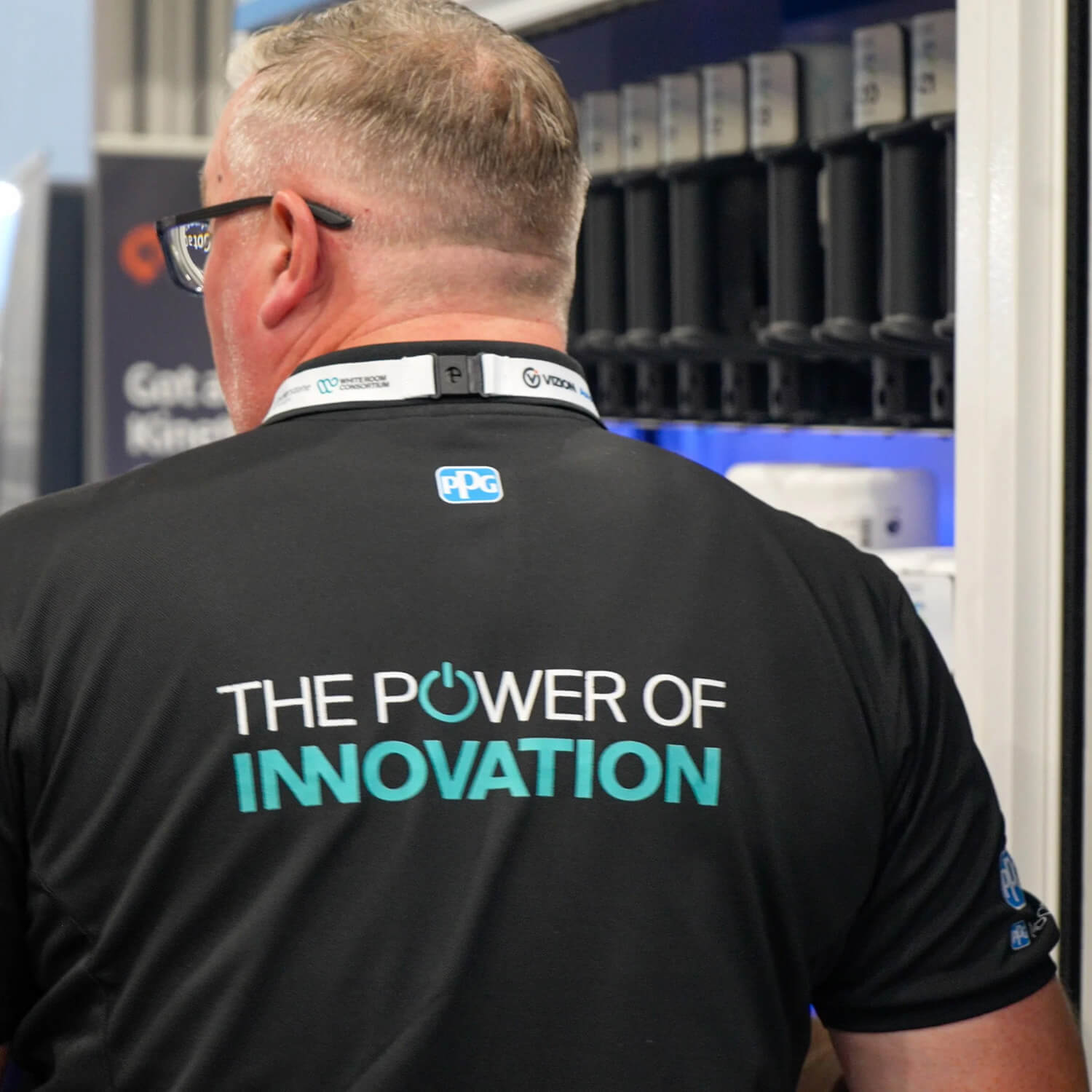 Exhibitor with branded t-shirt showing 'The Power of innovation'