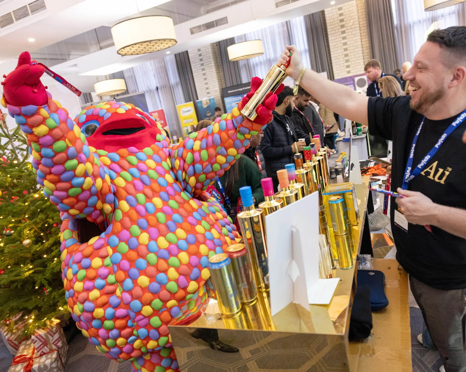 AU Vodka exhibitor interacting with a colourful mascot