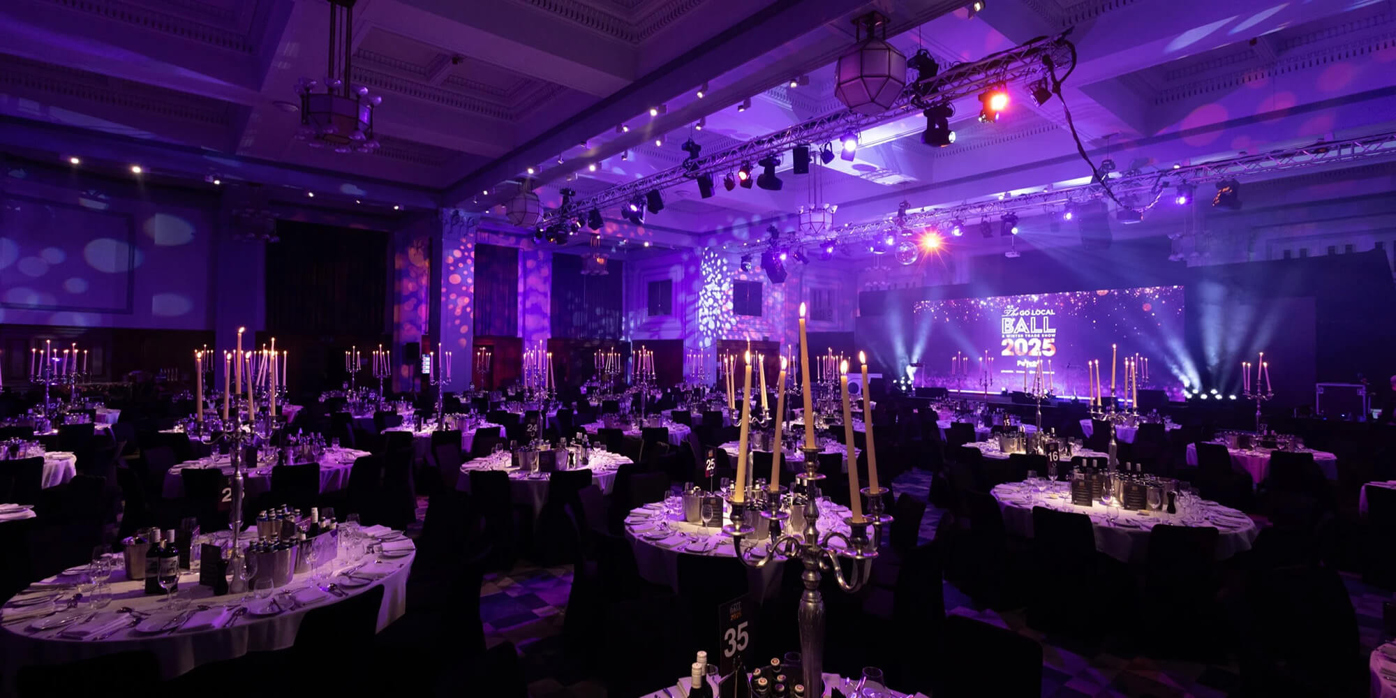 Evening dinner cocktail table setup with purple lighting