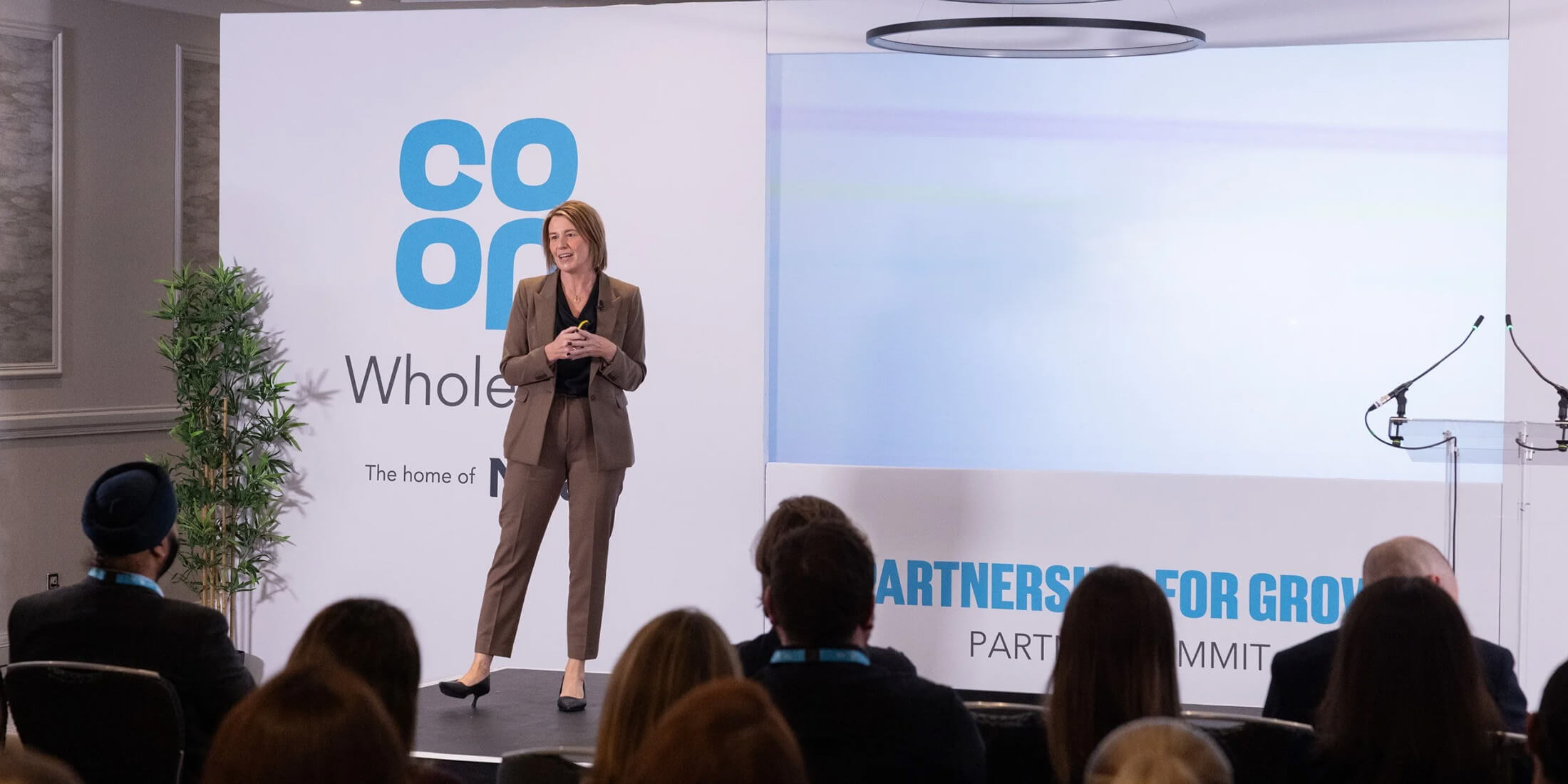 Guest speaker on the stage during the Co-op Wholesale: A Partnership for Growth