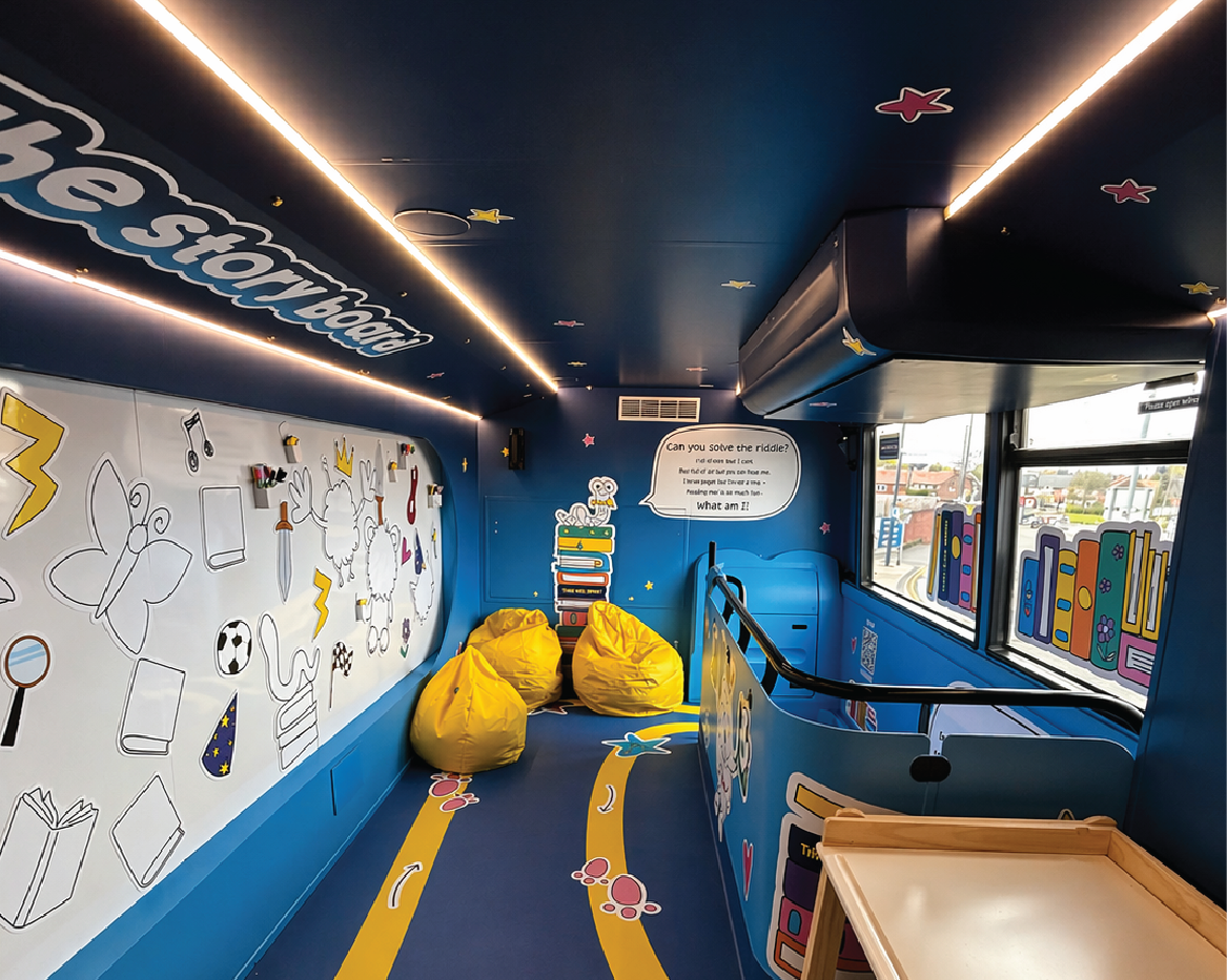 The Works: 'Find your Story' Bus inside with branded wall art and yellow beanbags