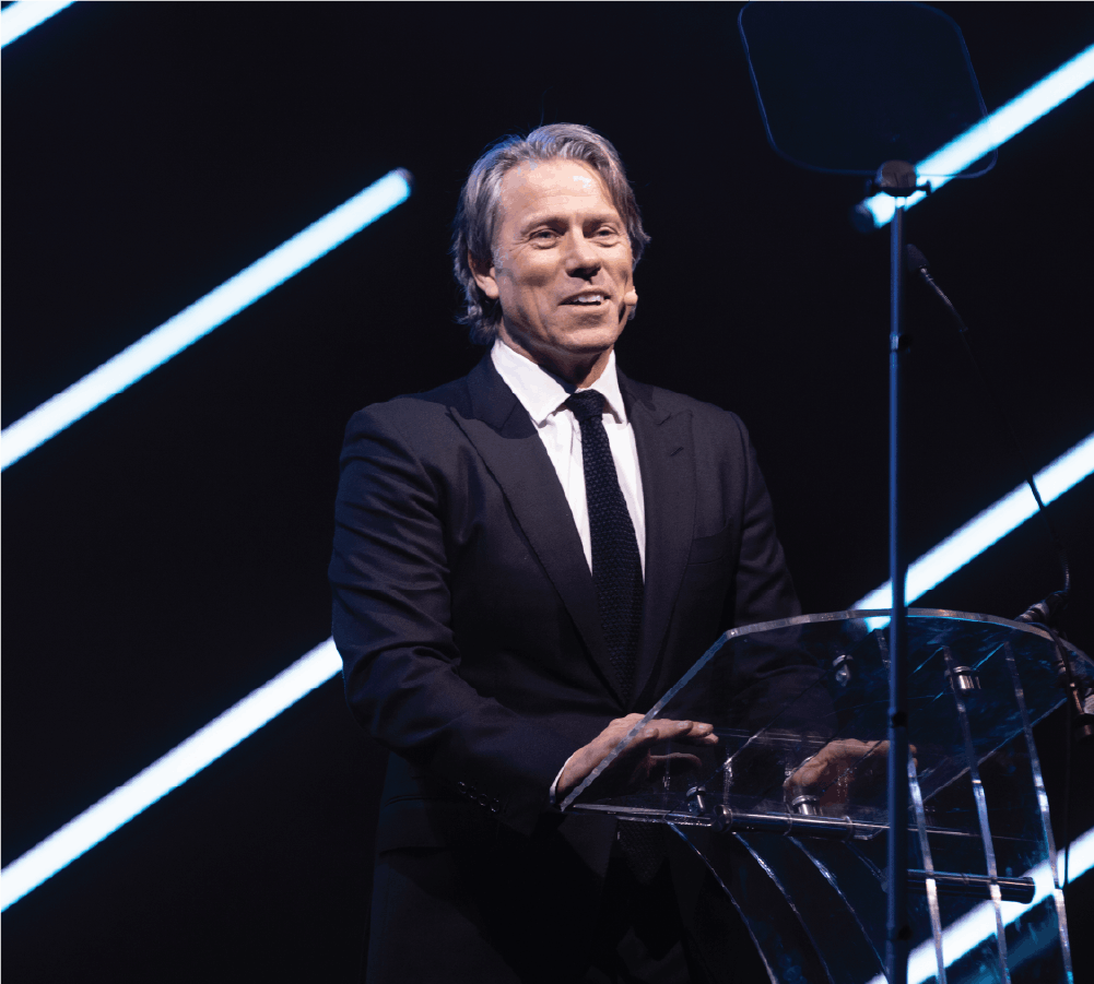 Guest host John Bishop presenting on stage