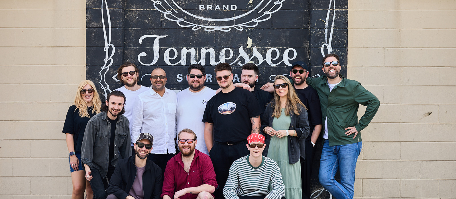 Attendees together for a group photo with Jack Daniel's flag outside