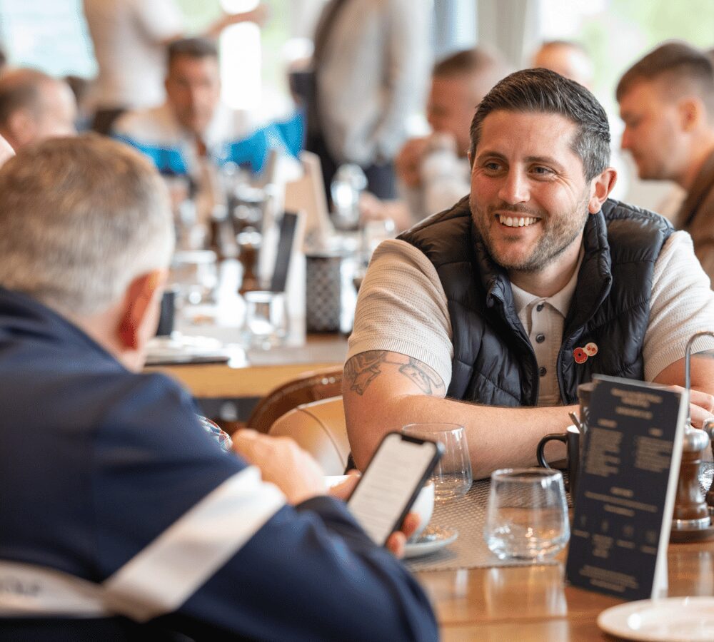 Guests networking over refreshments during a corporate golf day hospitality event