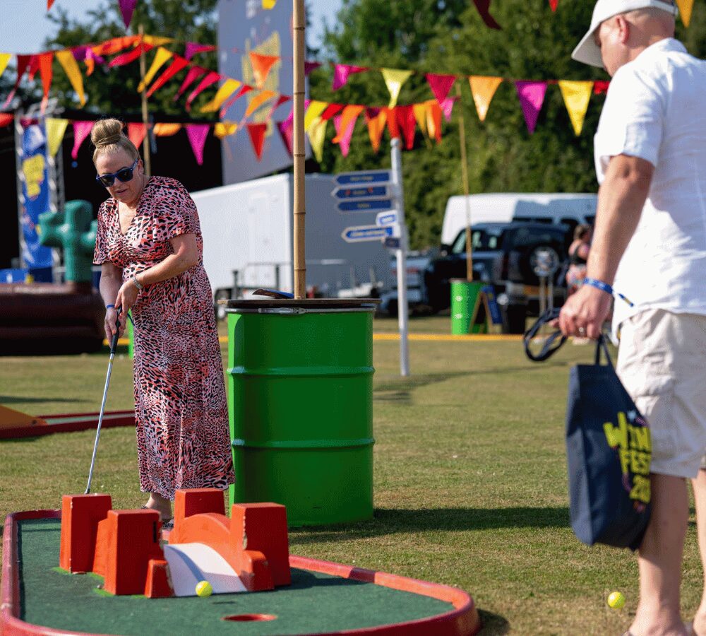 Visitors playing mini golf