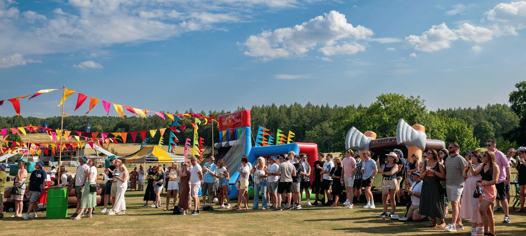 Crowd enjoying the Windsor Festival with fairground attractions and live entertainment