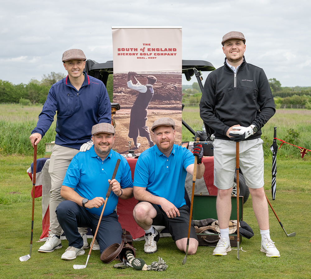 Golf day team posing with clubs and buggy during the FP McCann The Grandiose Golf Day