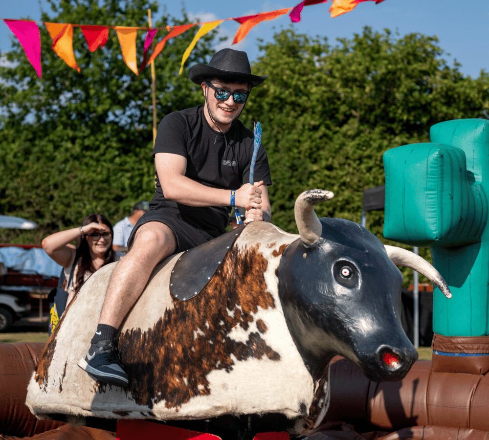 Person riding an inflatable rodeo bull